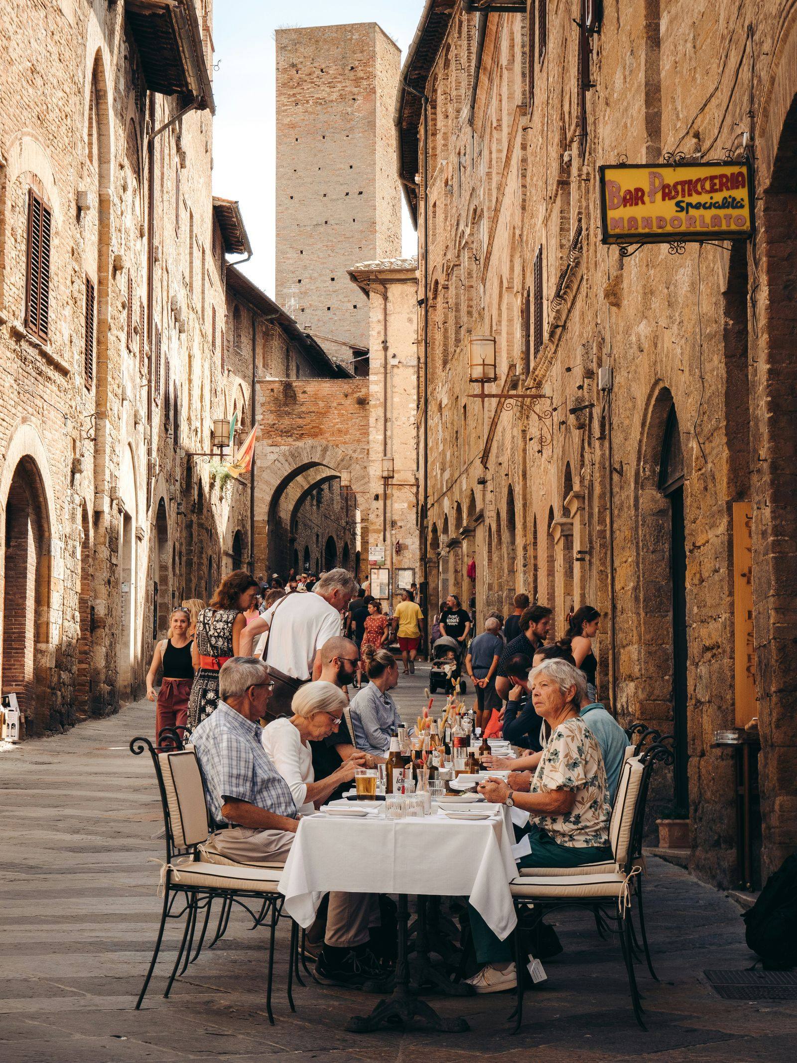 Terrasse de restaurant dans une ruelle médiévale italienne, univers food et gastronomie